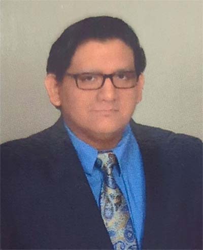 Portrait of Michael Vega, he is in business attire